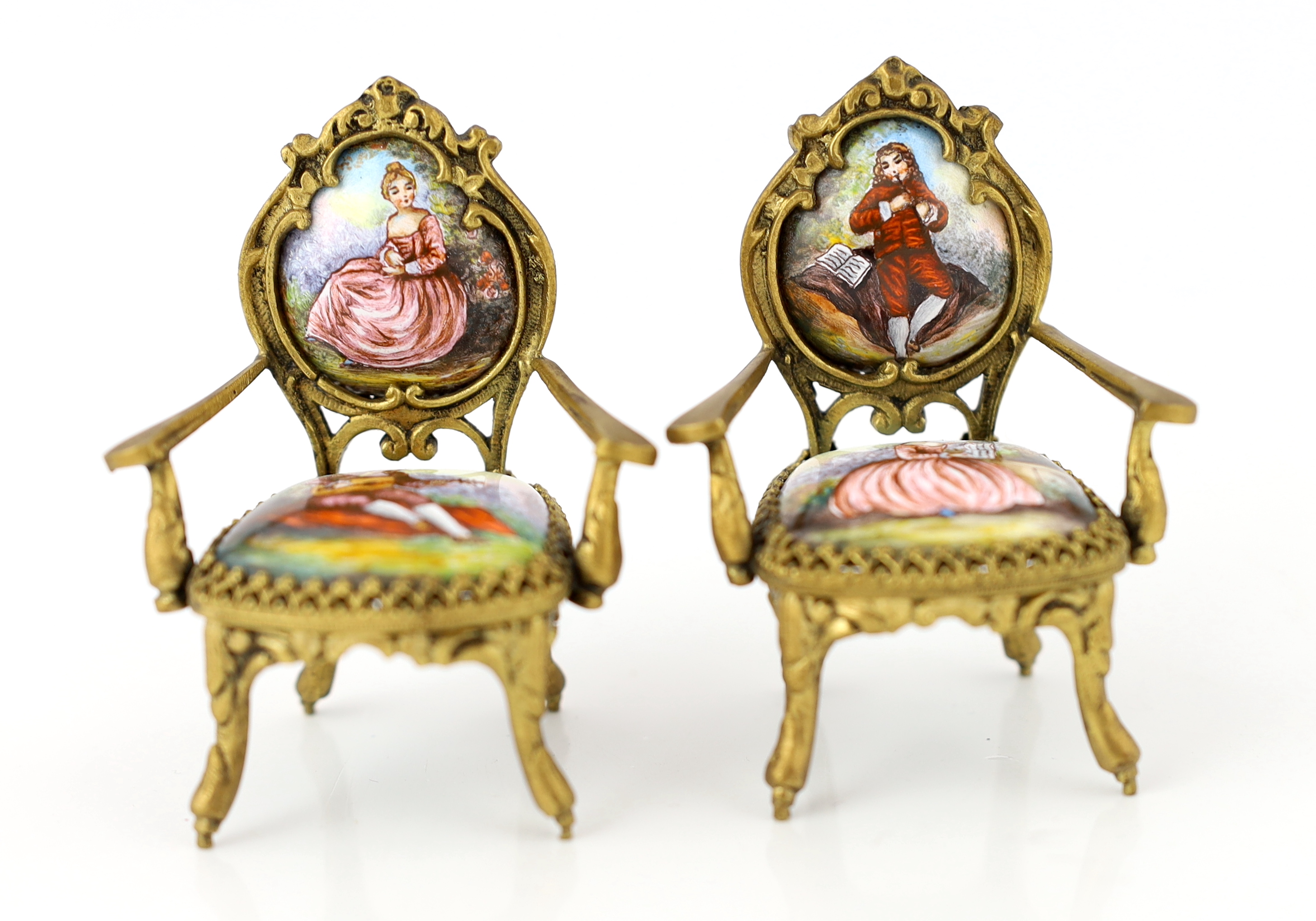 A 20th century Swiss enamel and ormolu musical miniature doll's house table with a pair of matching salon chairs, table 9.5 x 7.5cm, 5cm high, chairs 7cm high